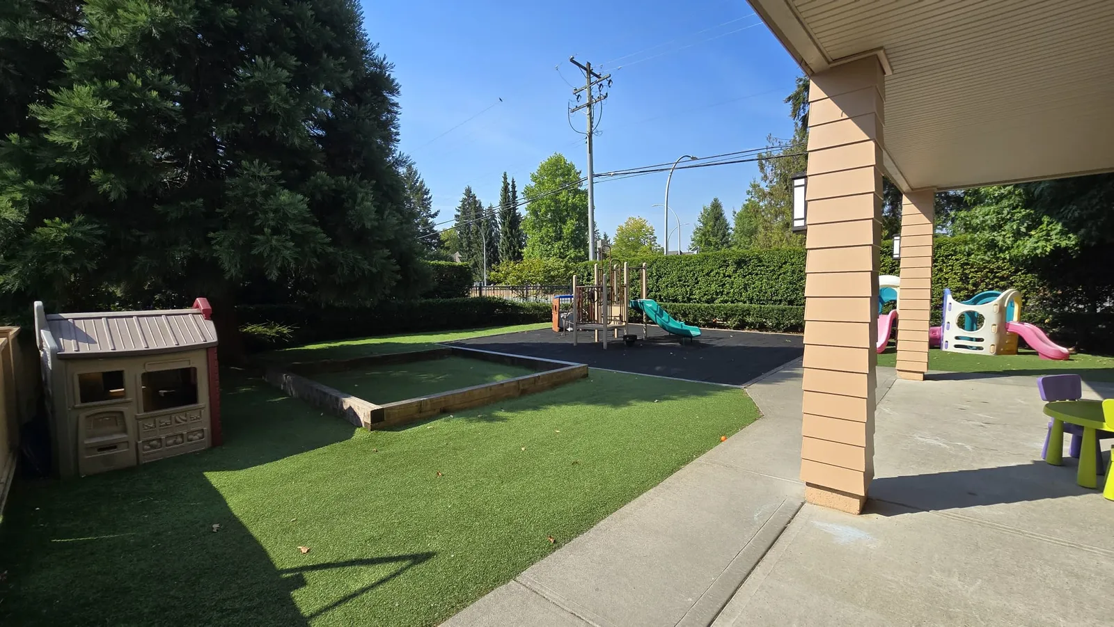 the 3 to 5 program playground with turf, a sandbox, a playhouse and a climber with a slide