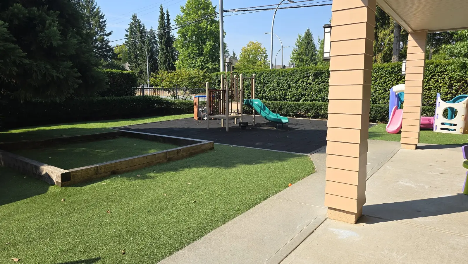 the 3 to 5 program playground with a sandbox, soft turf and a climber with a slide