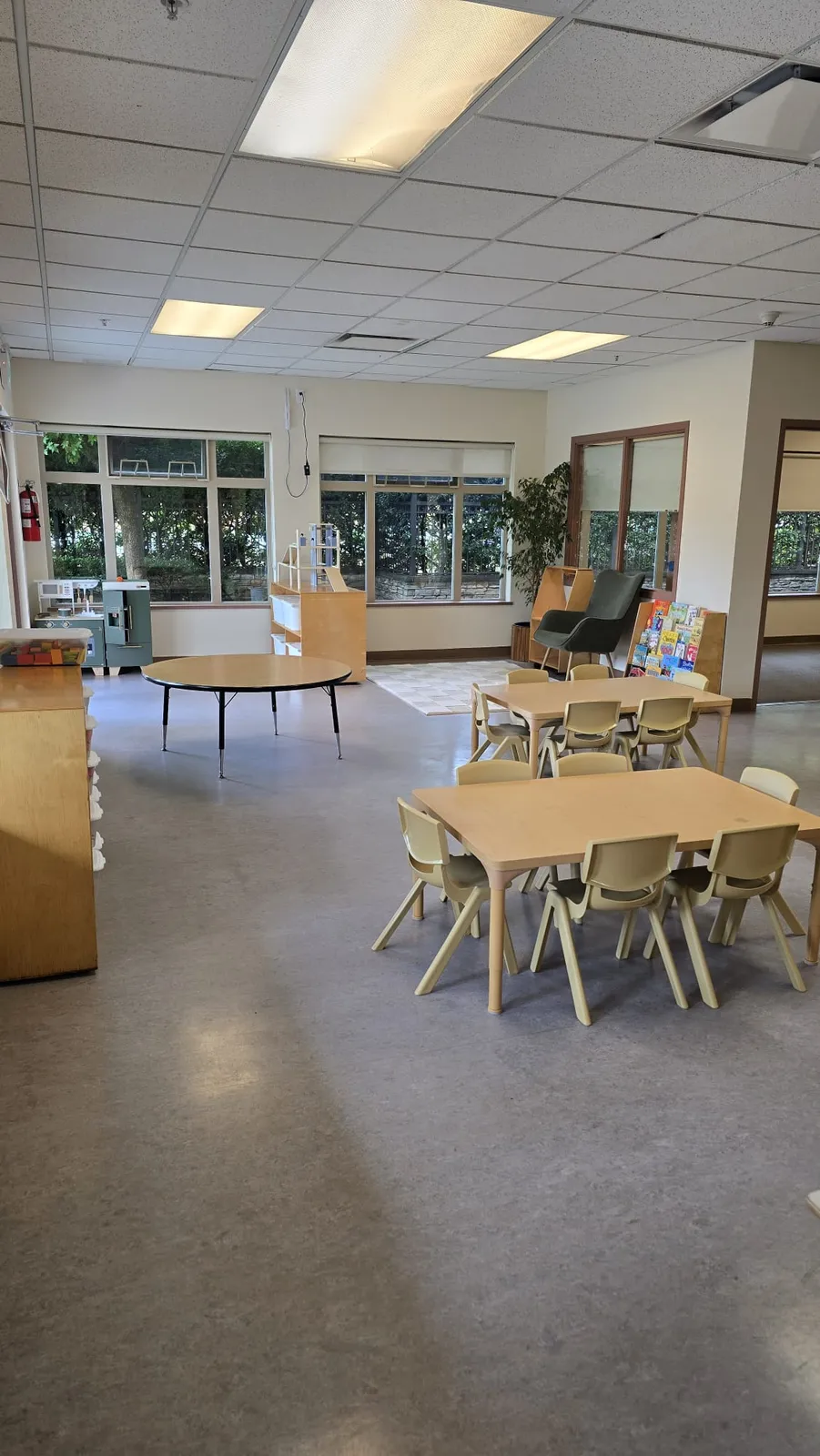 the reading chair, book display and play kitchen in our 3 to 5 program space
